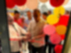 Launching a side hustle while working full-time, man, cutting the ribbon to his grand opening