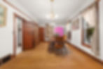 Vintage dining room with wooden table and chairs, pink cabinet, open door, curtained windows, and chandelier.