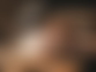 Hands writing in a notebook on a rustic wooden table, with woodworking tools and shavings. Warm sunlight creates a calm, focused mood.