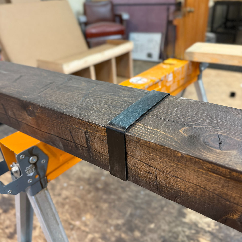Black aluminum bracket on wood beam