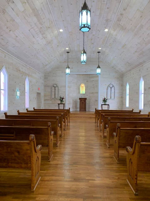 interior of Jackson Street Chapel showing pews and stage.