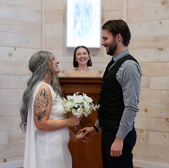 wedding ceremony with bride groom and officiant in chapel setting