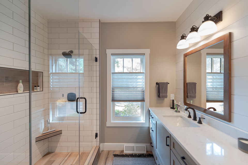 Master bathroom remodel with double vanity, custom cabinetry, Graber custom window treatment and subway tile walk-in shower