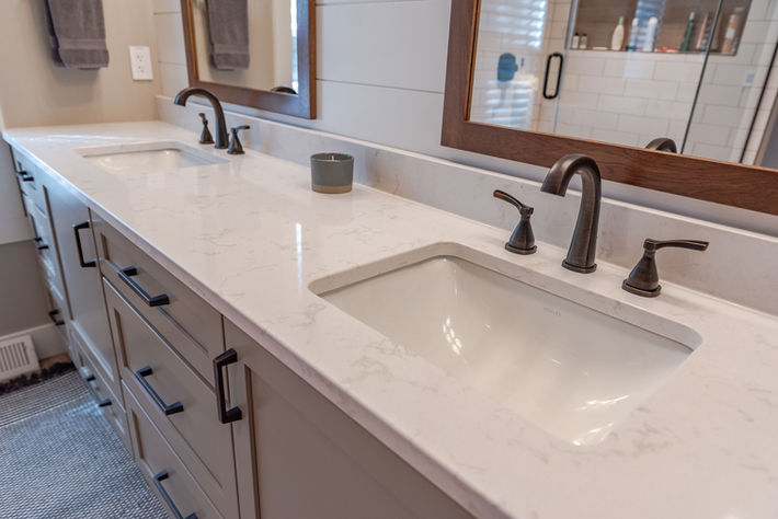 Double vanity with quartz countertop and custom cabinetry