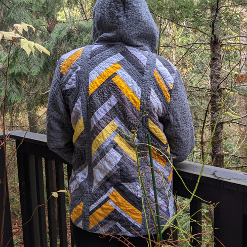 Directional, scrappy mullet quilt coat design