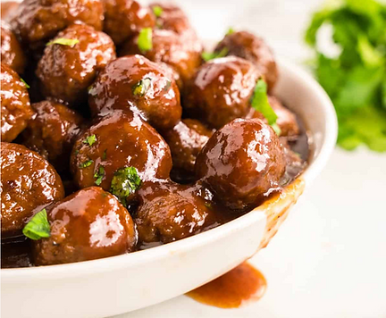 Slow cooked southern grape jelly meatballs in a white bowl