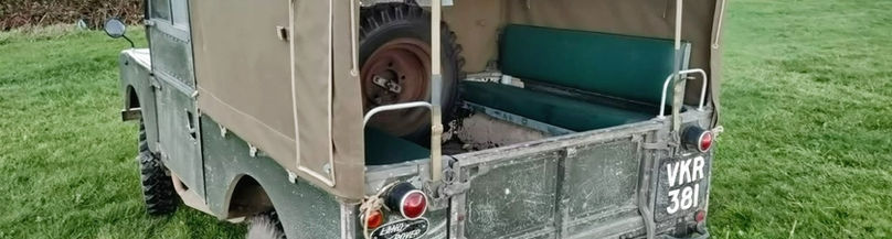 Back, side view of a 1956 Green Land Rover