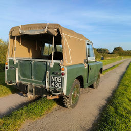 Rear view of a vintage Series 2 Land Rover in field