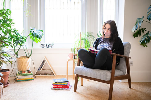 woman-sitting-on-chair-backlit-reading-book-at-personal-brand-photo-session-with-aberdeen-