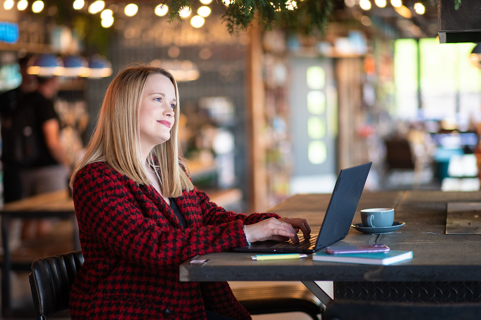 woman-in-red-blazer-working-on-laptop-in-brewdog-with-festive-atmosphere-at-personal-brand