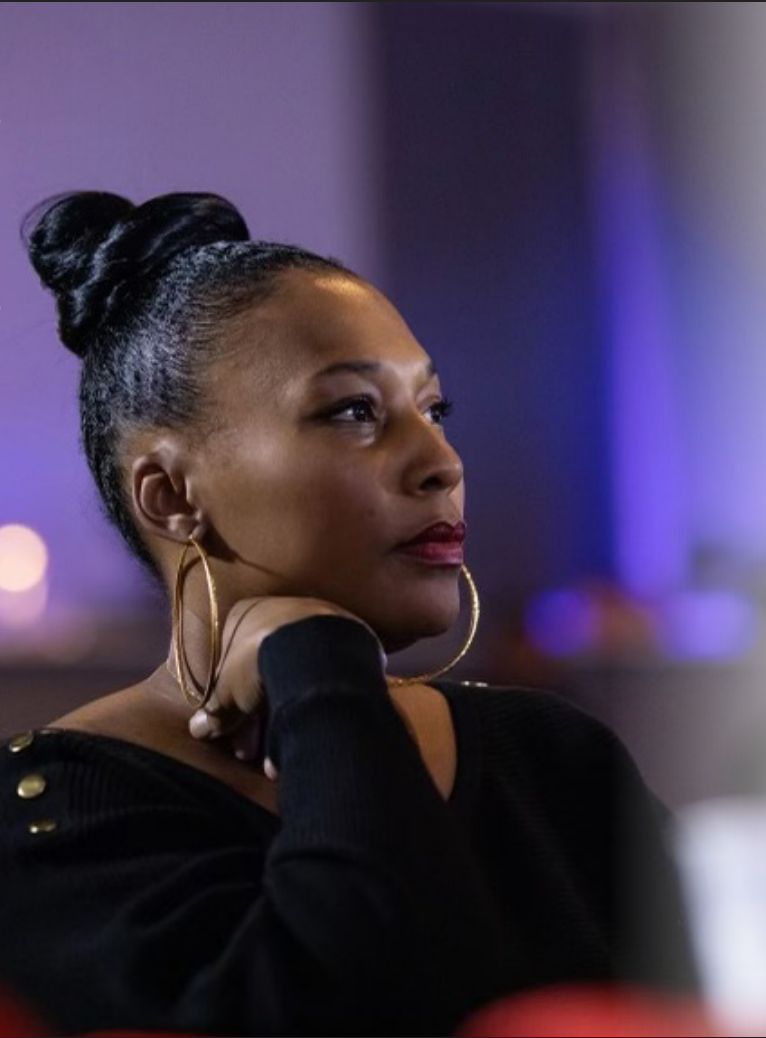 Black woman wearing gold hoop earrings