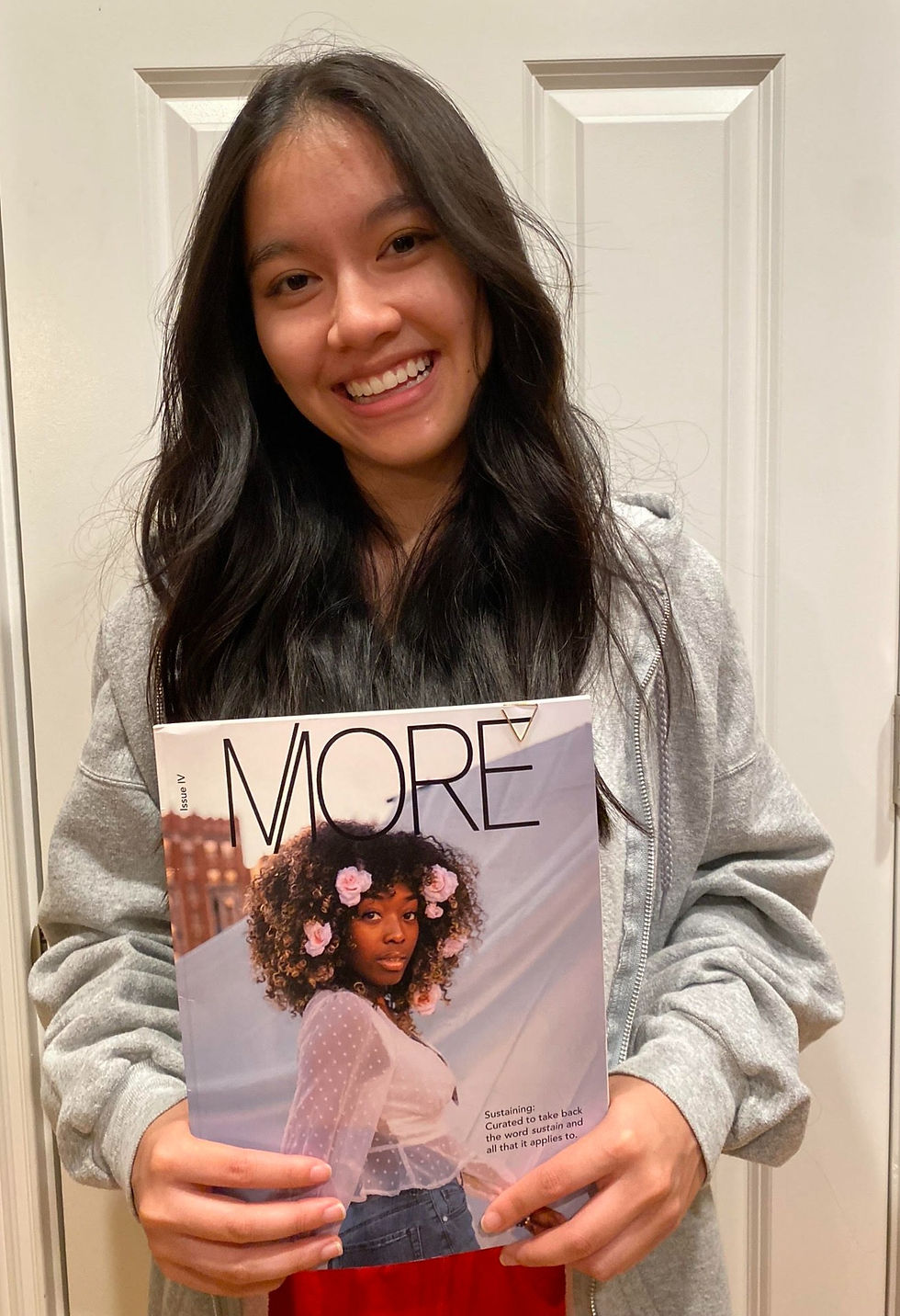 Young woman holding issue IV of MORE Magazine