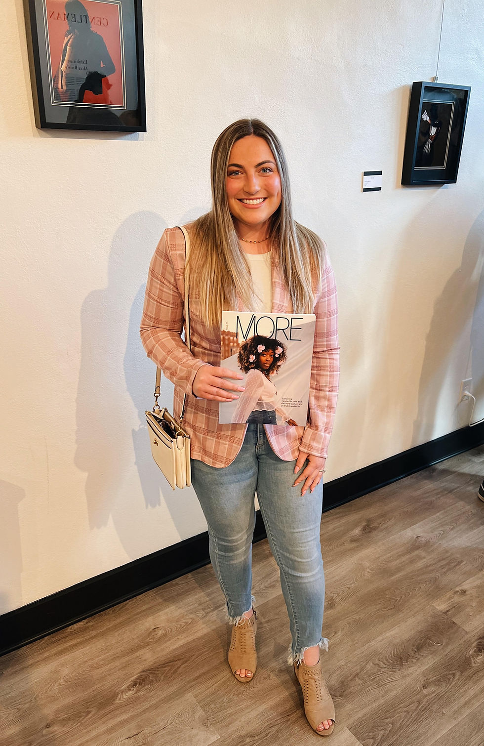 Young woman standing holding issue IV of MORE Magazine