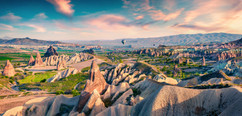 unreal-world-of-cappadocia.-colorful-sunrise-in-red-rose-valley-in-april.-cavusin-village