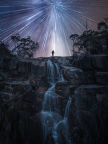 Man standing on top of the waterfall