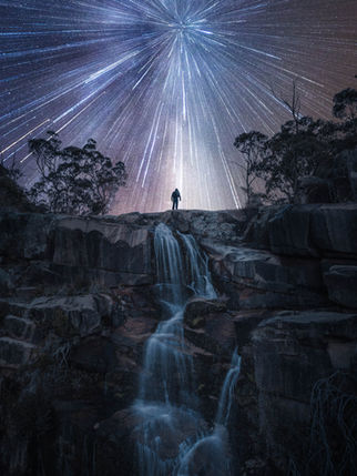 Man standing on top of the waterfall