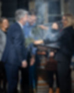 Guests taking part in a smoking ceremony during a Welcome to Country at an official event.