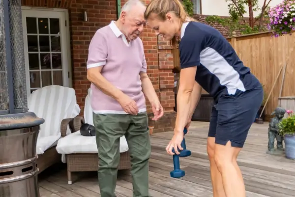 Physiotherapist and client performing gentle exercises to support ongoing rehabilitation
