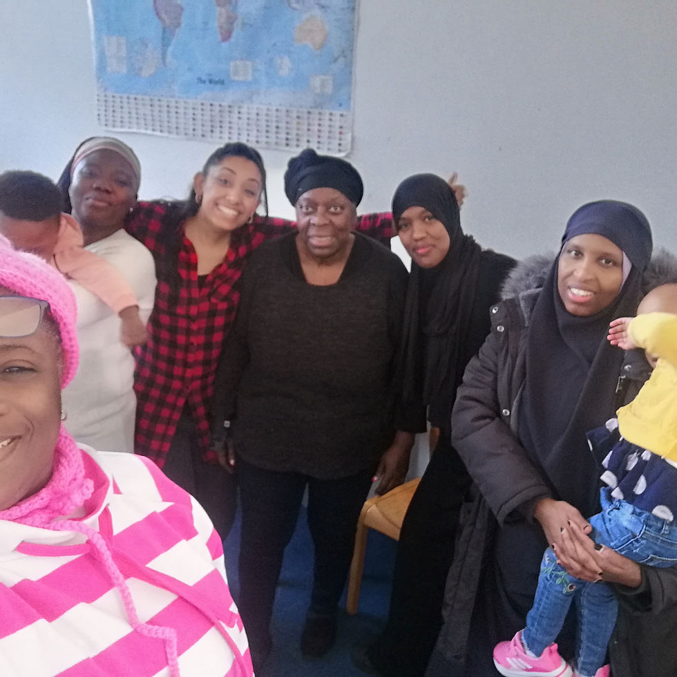 Group of women smiling, some holding babies
