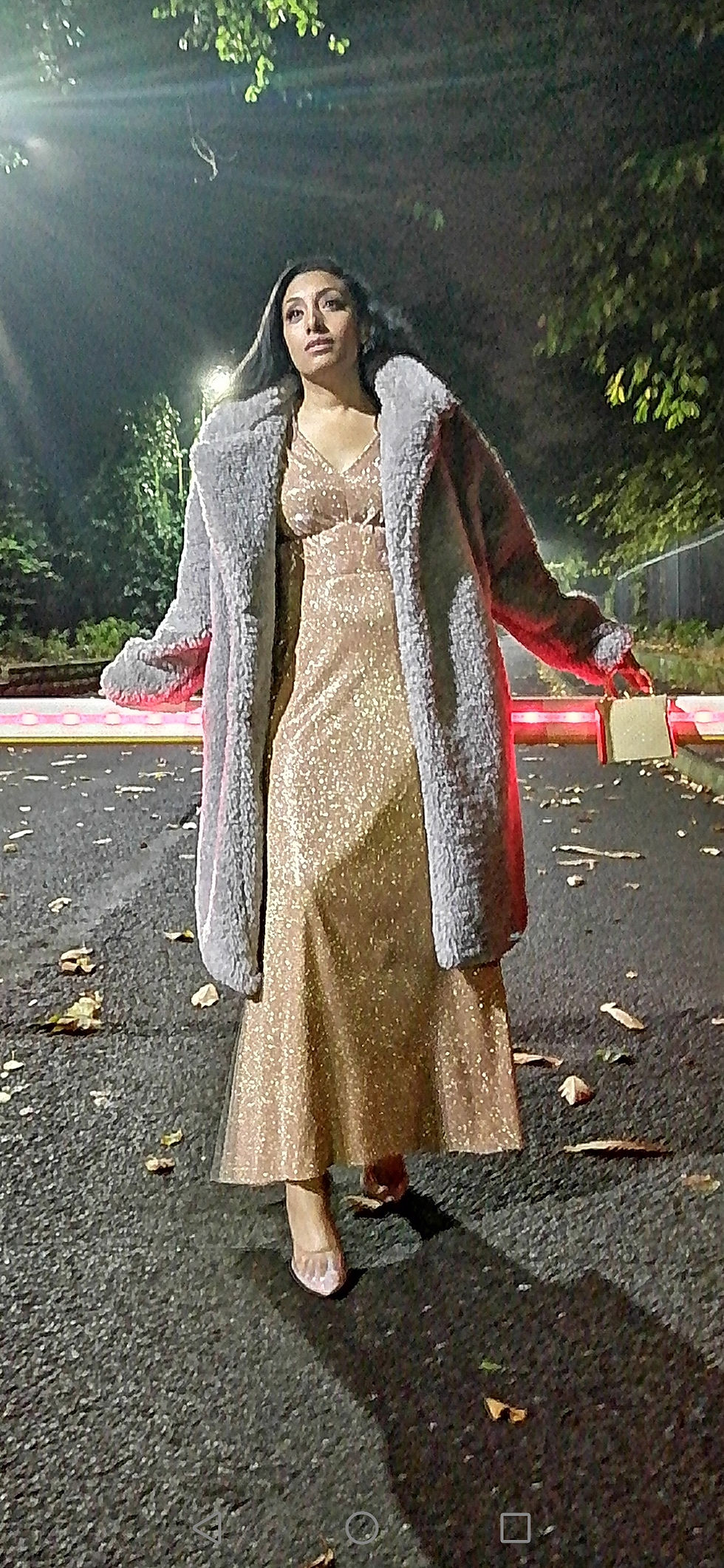 Woman in a long dress and fluffy grey coat