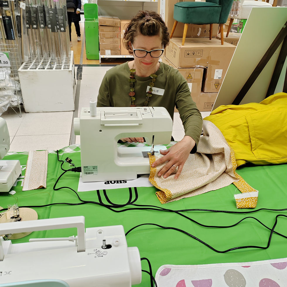 Woman sewing with a machine in a local sewing class for beginners.