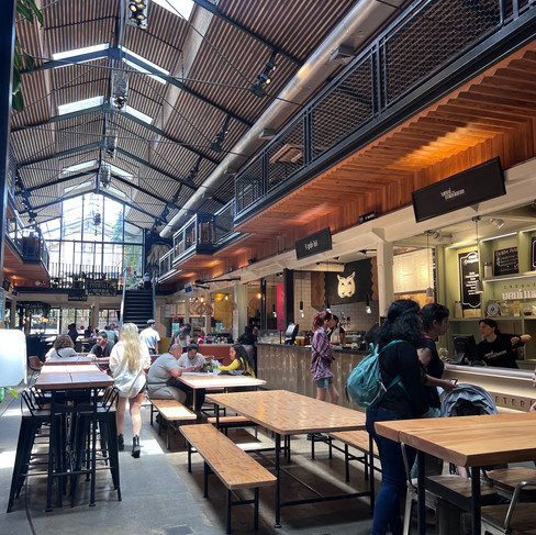 inside Mercado Ferranda with tables and food stalls