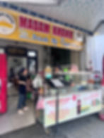 outside window of madam khanh banh mi sandwich shop with two workers behind the counter