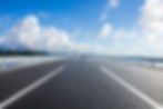 Straight asphalt highway and skyline under blue sky.jpg