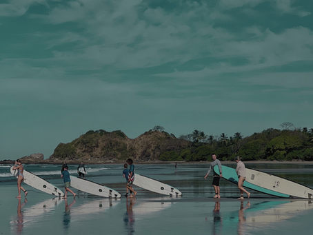 surfers at playa Guiones Nosara