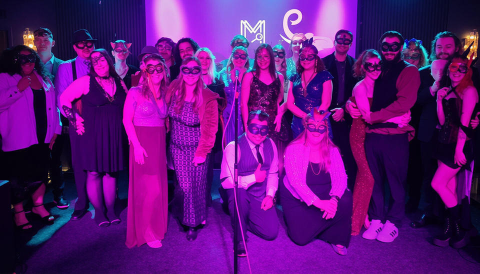 a group dressed in masquerade attire