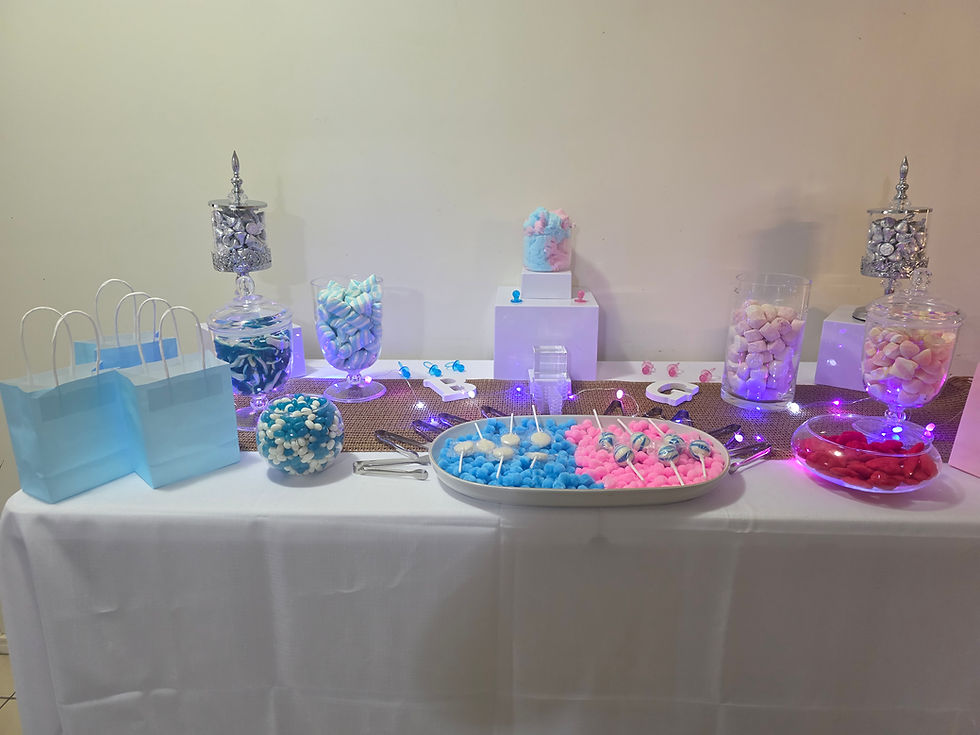 Gender reveal candy table with themed sweet display