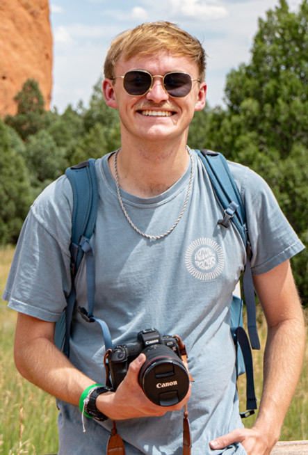 Man with video camera poses for picture at Garden of the Gods