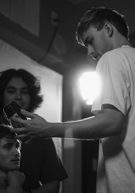 Man shows clients picture as he directs them in shoot