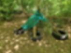 A child's den made from tyres, planks and nets in a forest setting