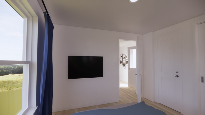 Bedroom and entry view in The Caraquet mini home with wall-mounted TV, door, and window light.