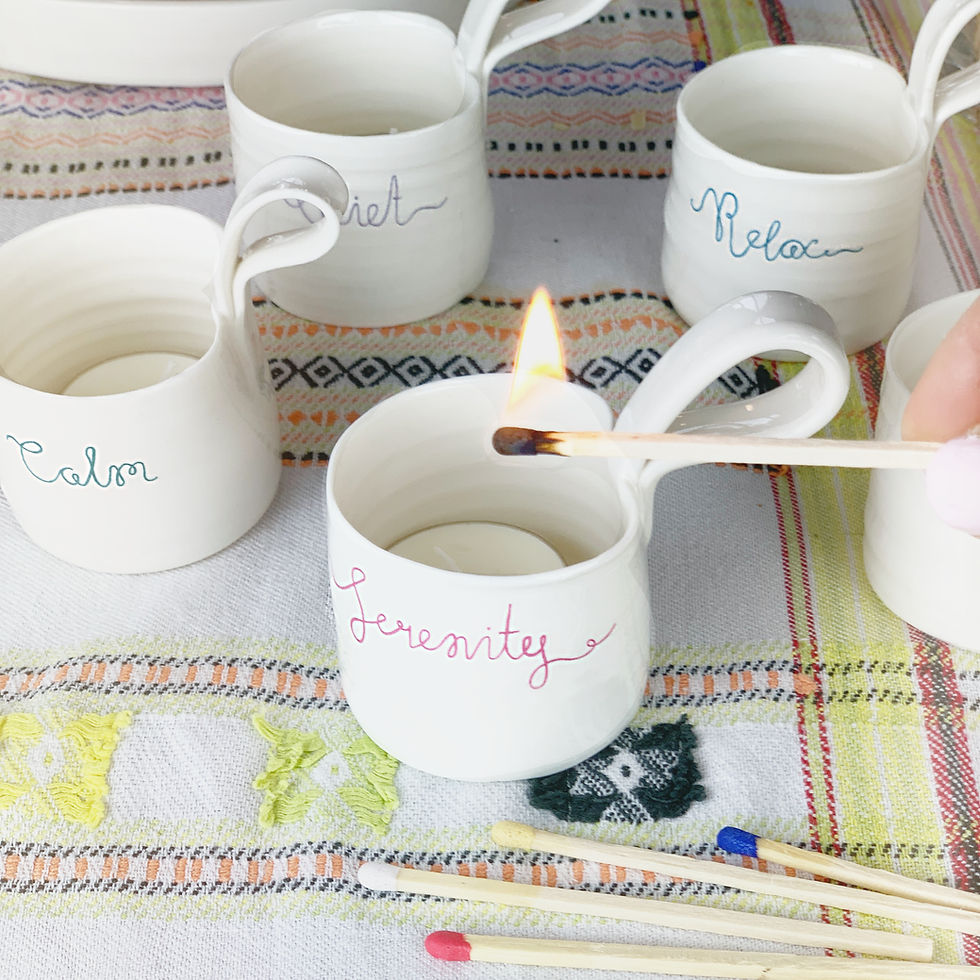 Thumbnail: Serenity porcelain candle tea light holder with handle being lit