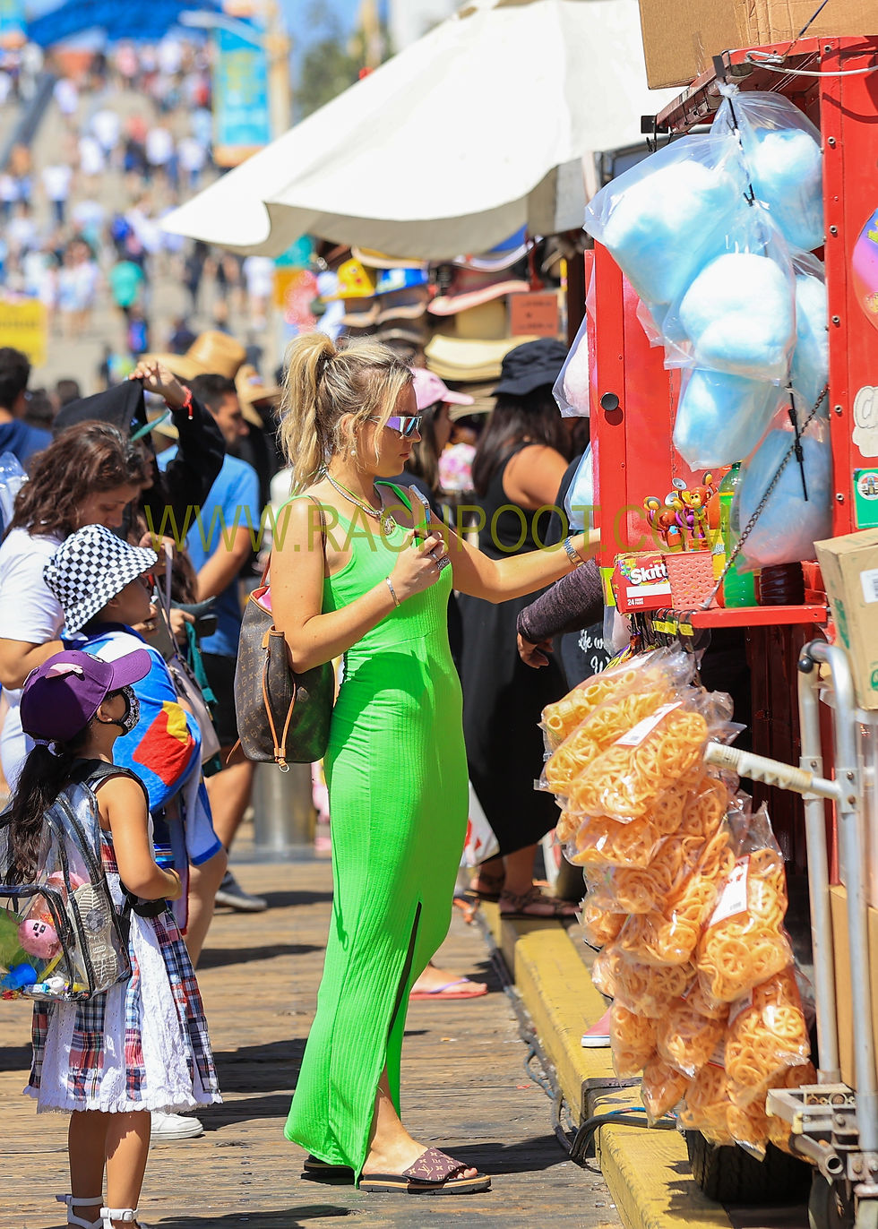 Tallia Storm seen on Santa Monica peer in a bright green dress