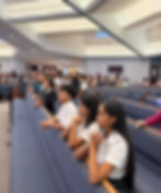 Close-up view of a child’s hands holding a rosary beads