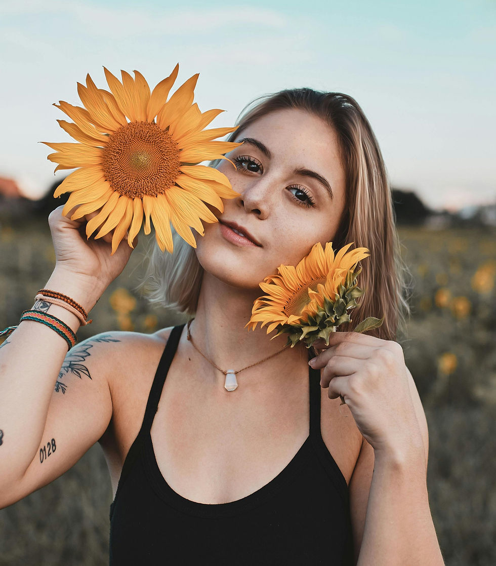 Woman holding yellow sunflowers