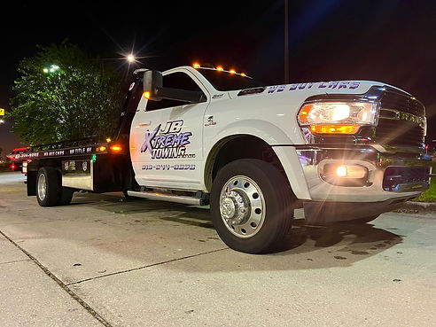 dodge rollback tow truck at night