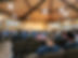 A group of men sitting in an auditorium listening to a speaker
