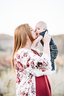 mom kisses baby