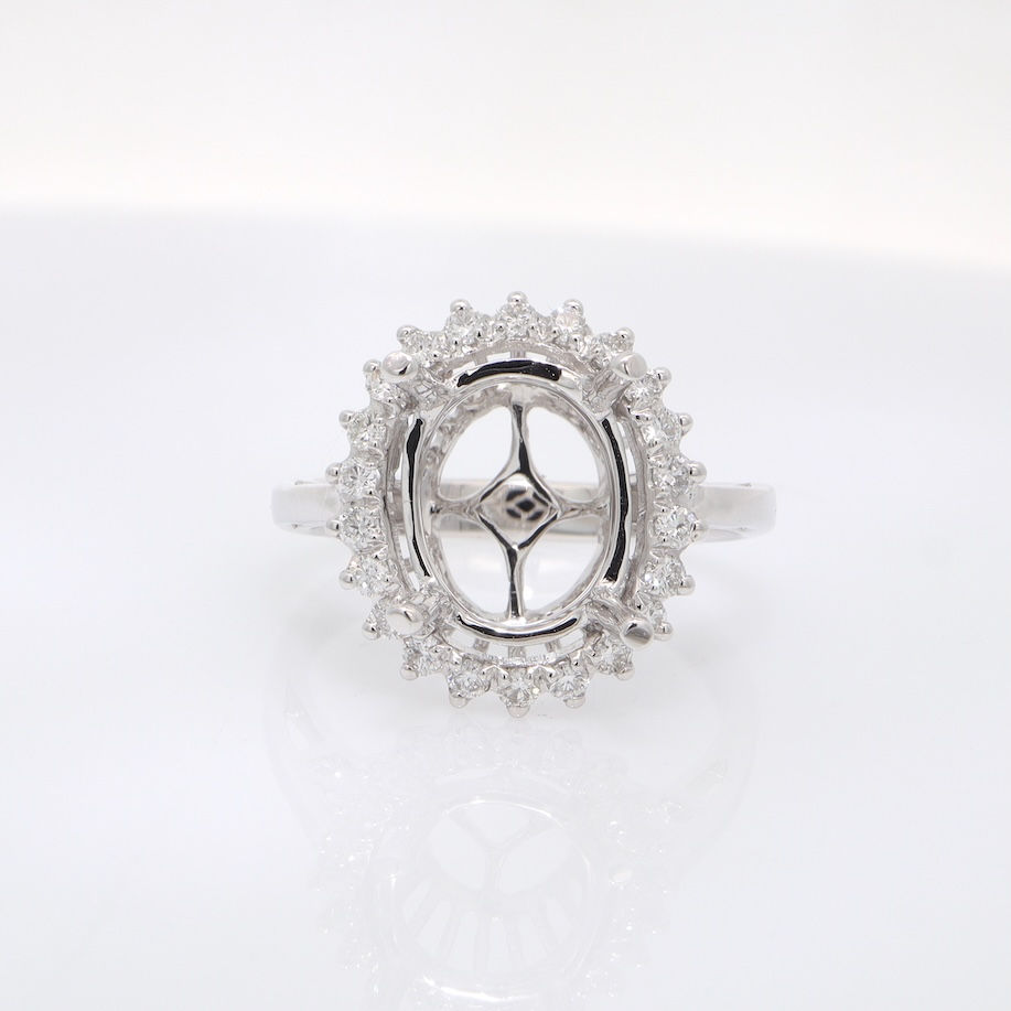 Vintage starburst halo diamond engagement ring setting for an oval stone in fine gold.