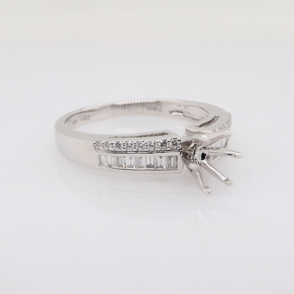 Thumbnail: Gold solitaire diamond ring with round and baguette diamonds
