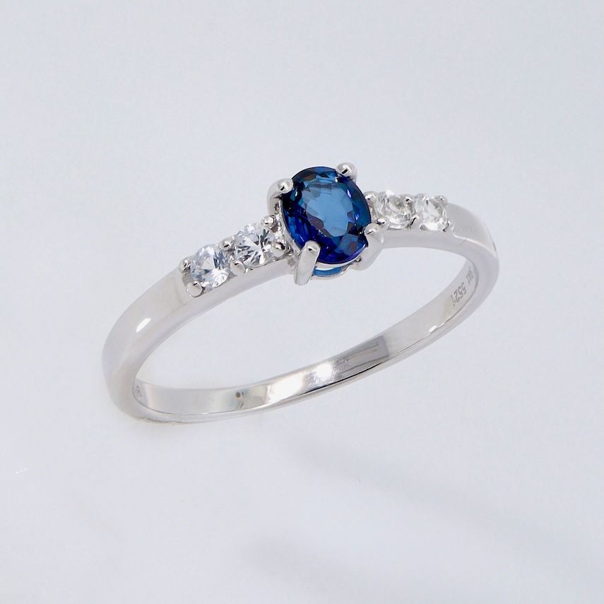 Oval blue sapphire engagement ring with diamond accents
