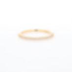Delicate pavé diamond ring with a minimalist half eternity design on a thin gold band.