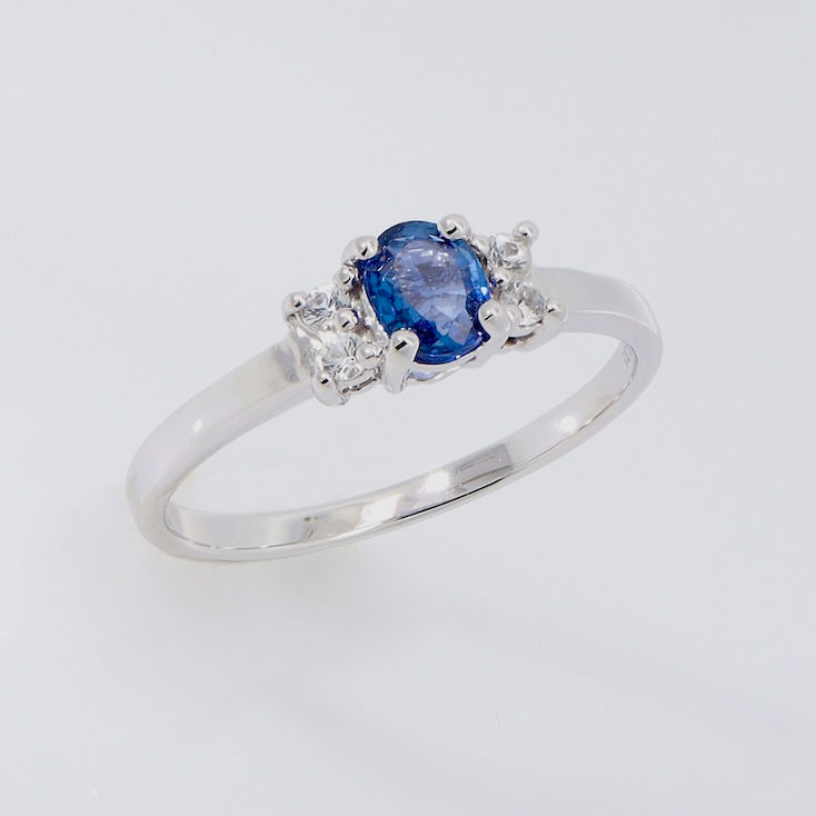 Oval blue sapphire ring with diamond accents in premium setting