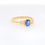 Thumbnail: Classic oval gemstone ring with three-stone baguette diamond accents on a gold band.