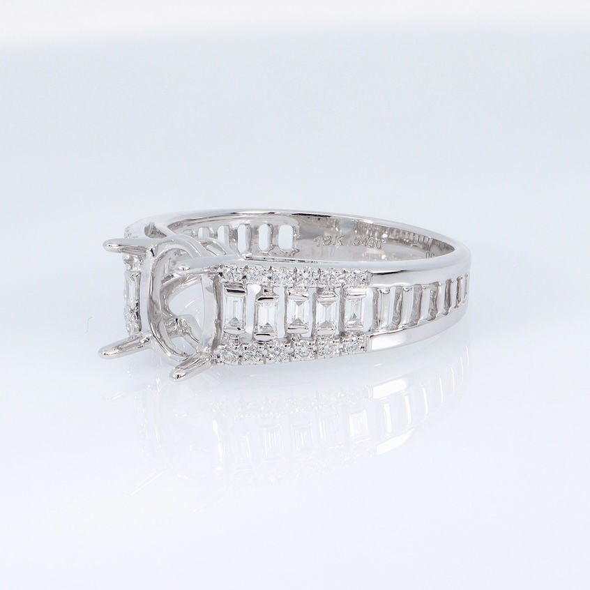 Thumbnail: Wide band engagement ring setting with channel-set baguette and pavé round diamonds in fine gold.