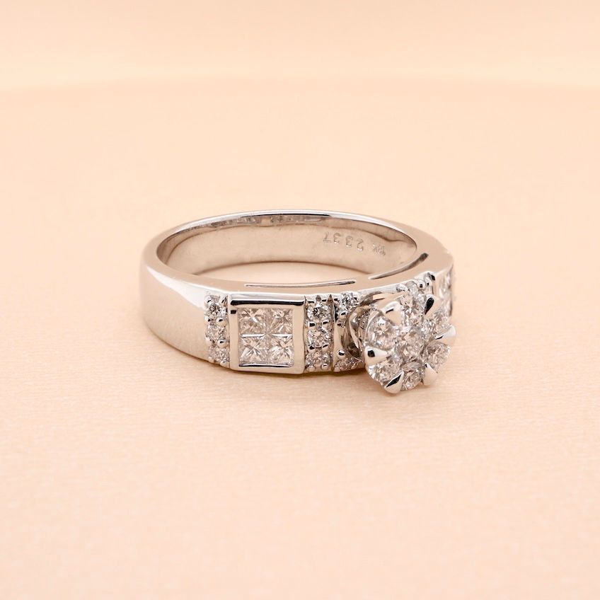 Thumbnail: Gold diamond solitaire engagement ring with cluster center stone and diamond band accents
